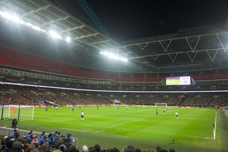 people playing football in a stadium