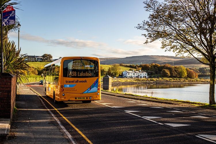 blue and yellow bus on the road during daytime