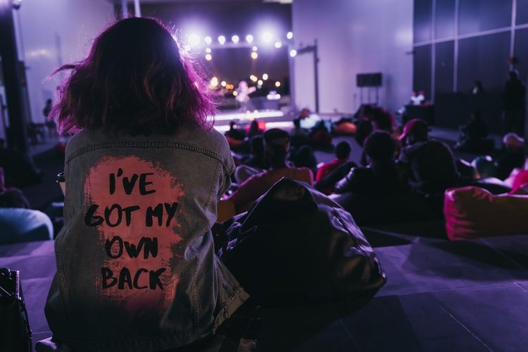 a young girl watching a music concert, light bulbs turned on during nighttime