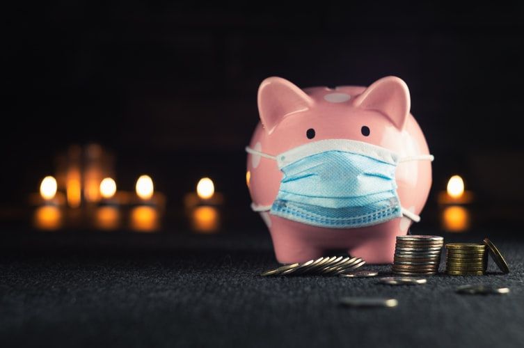 Piggy bank in a mask on background on blurry lights