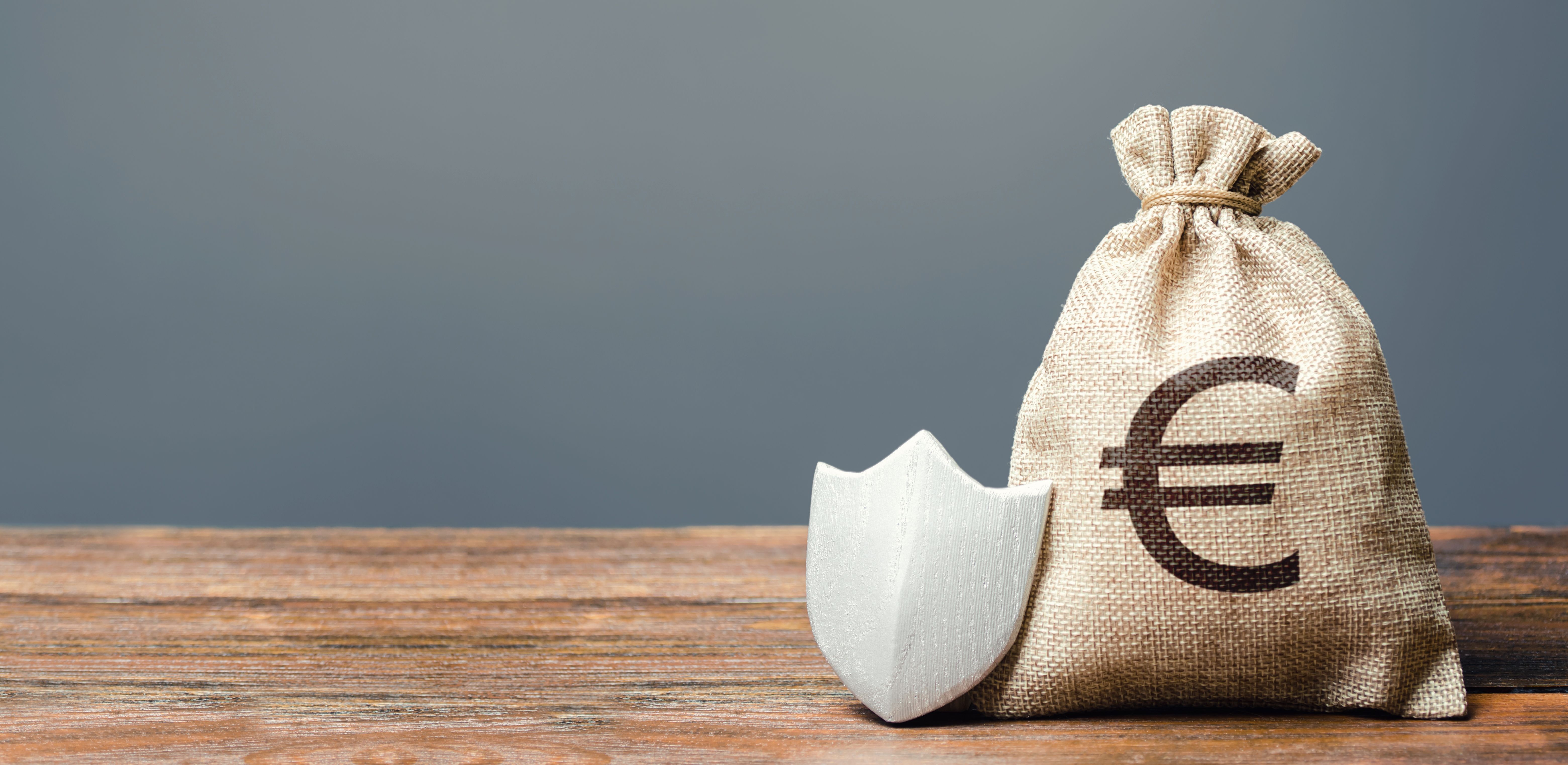 A guard beside a bag of money