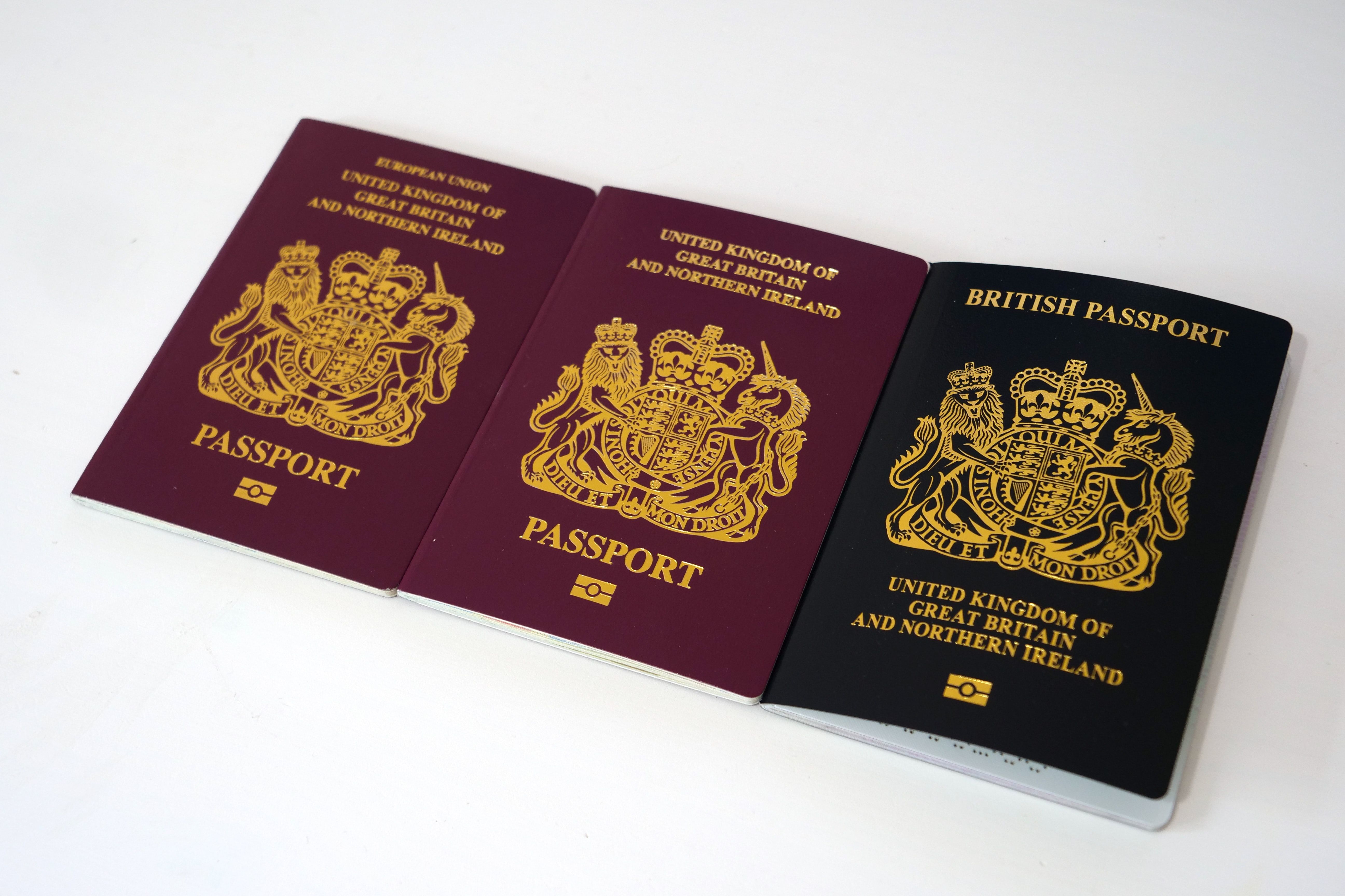 2 red British passports and one blue one on the right, demonstrating the ID check process when renting a property.