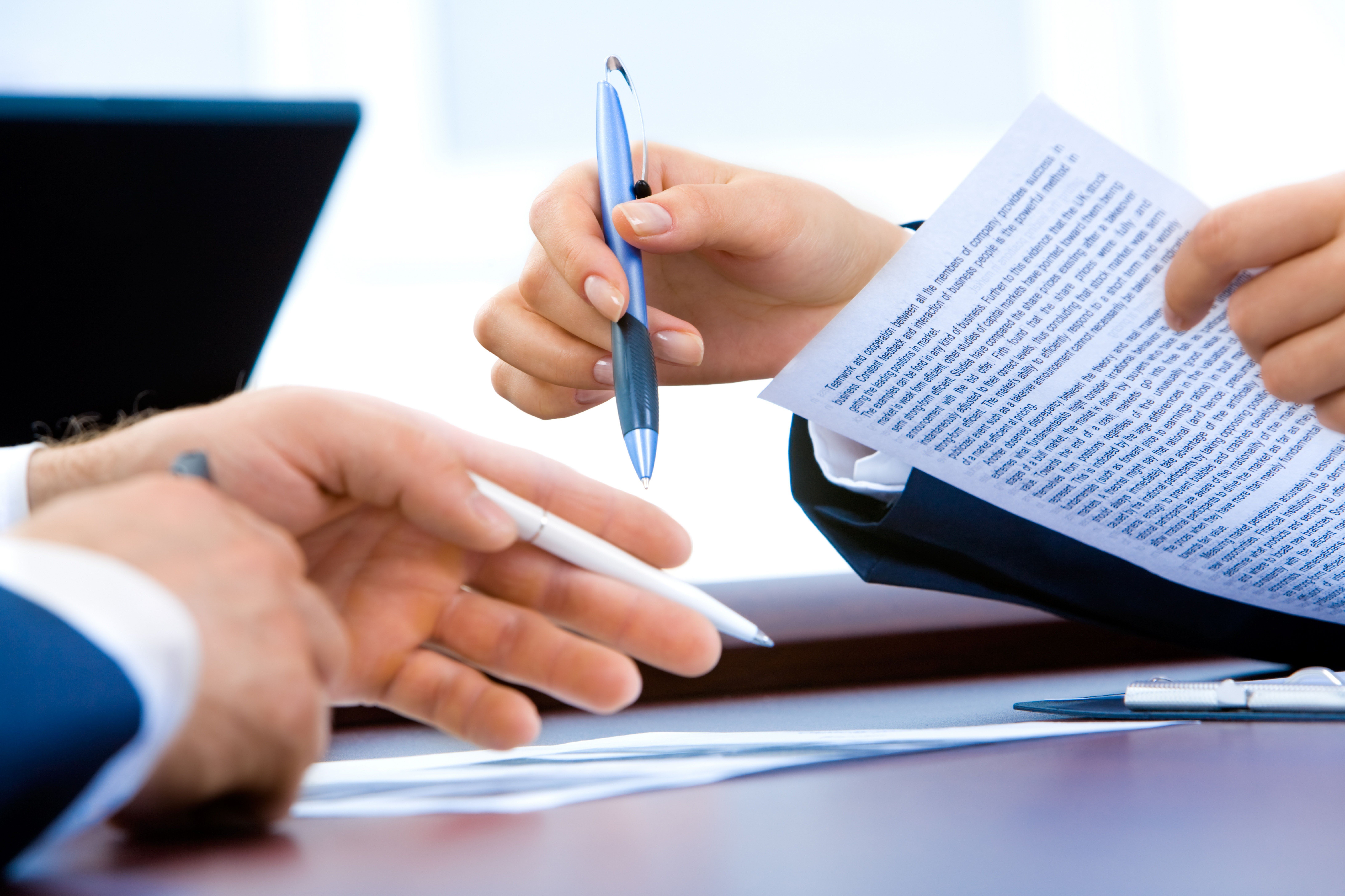 A landlord holding a grey pen and going through the list of acceptable right to rent documents to verify the tenant's.