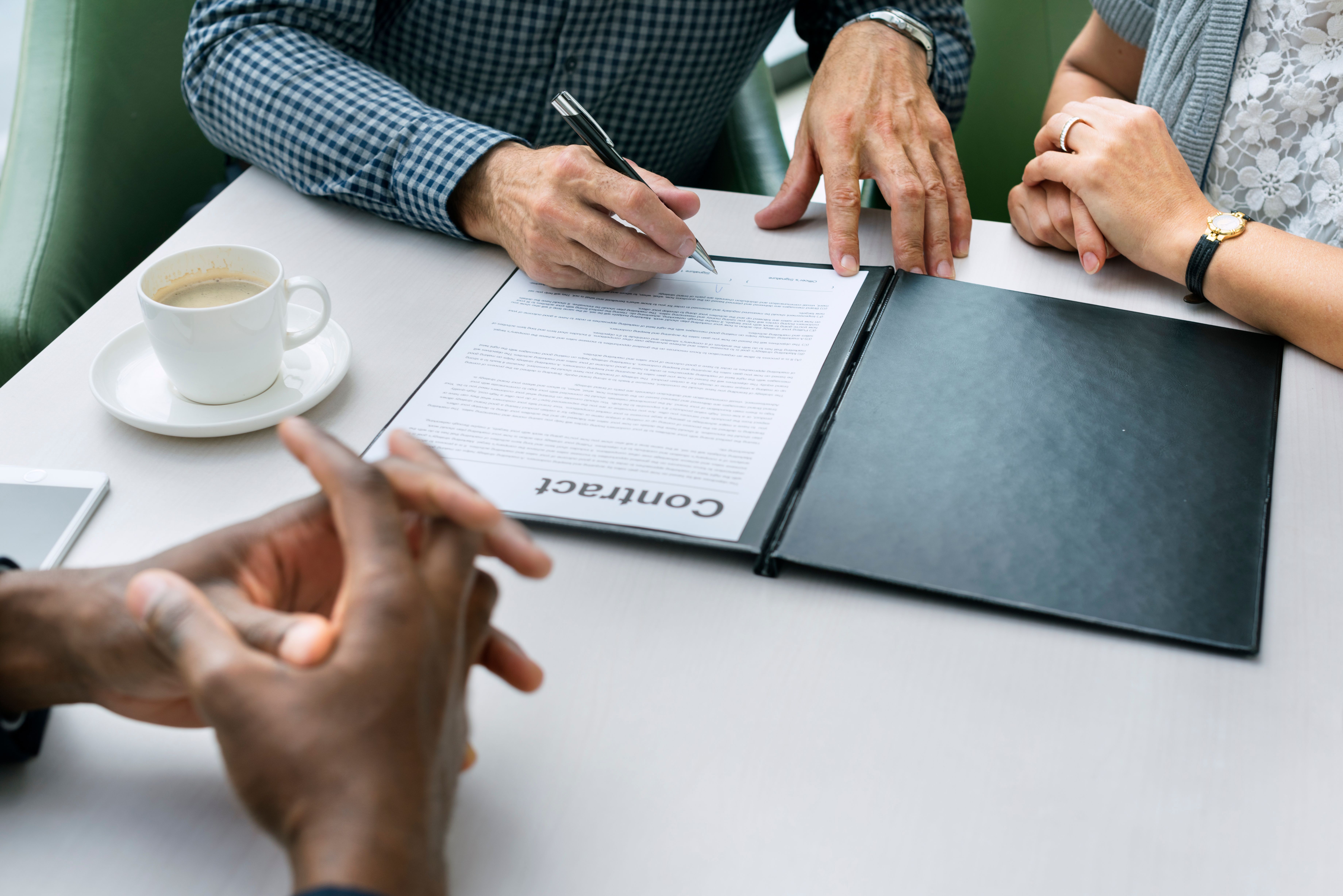 A guarantor co-signing a rental agreement with their tenant ahead of their moving into a new Build To Rent property.