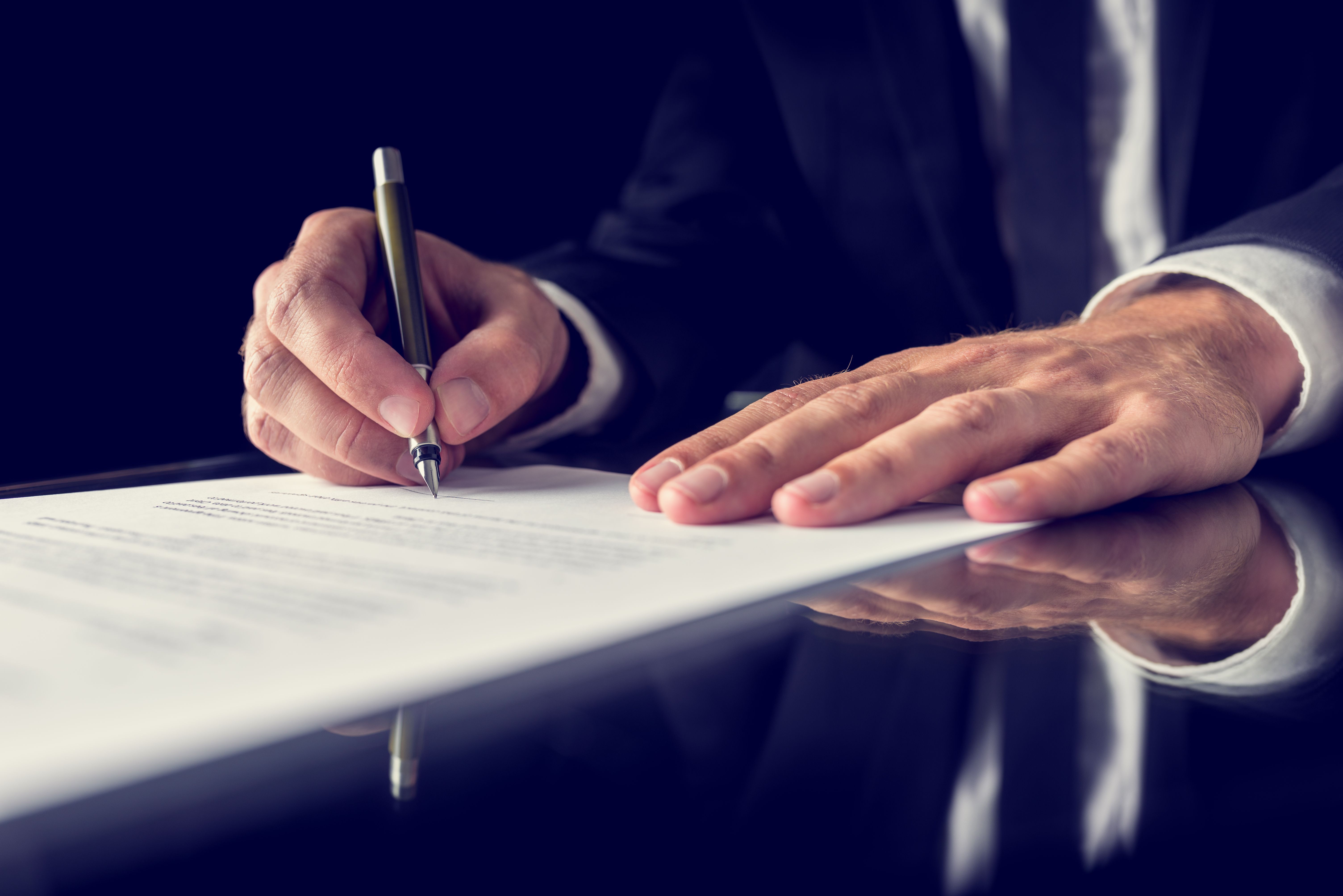 A guarantor signing a rent guarantee agreement, assuming all responsibility for the tenant's actions during his stay.