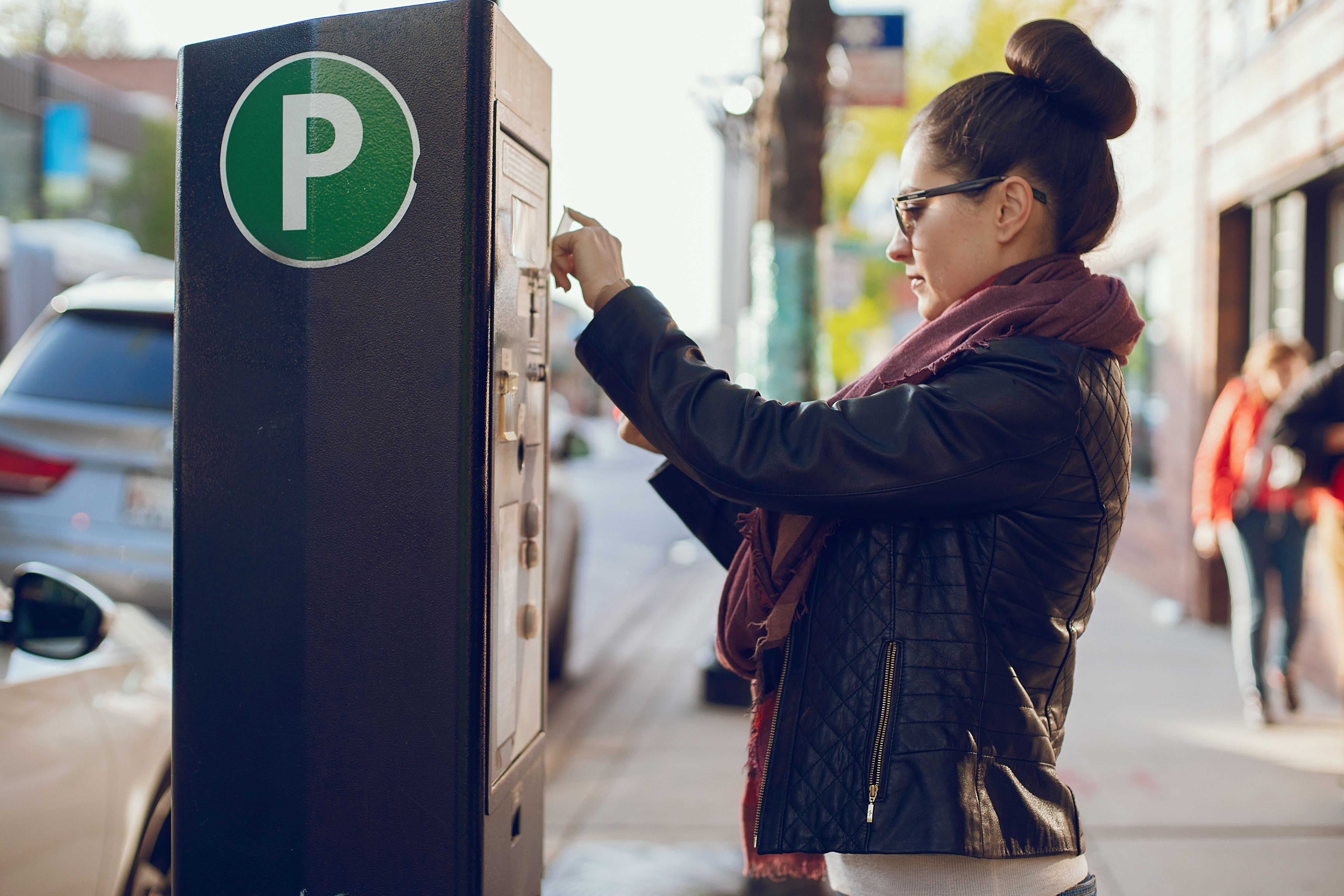 woman pays for parking