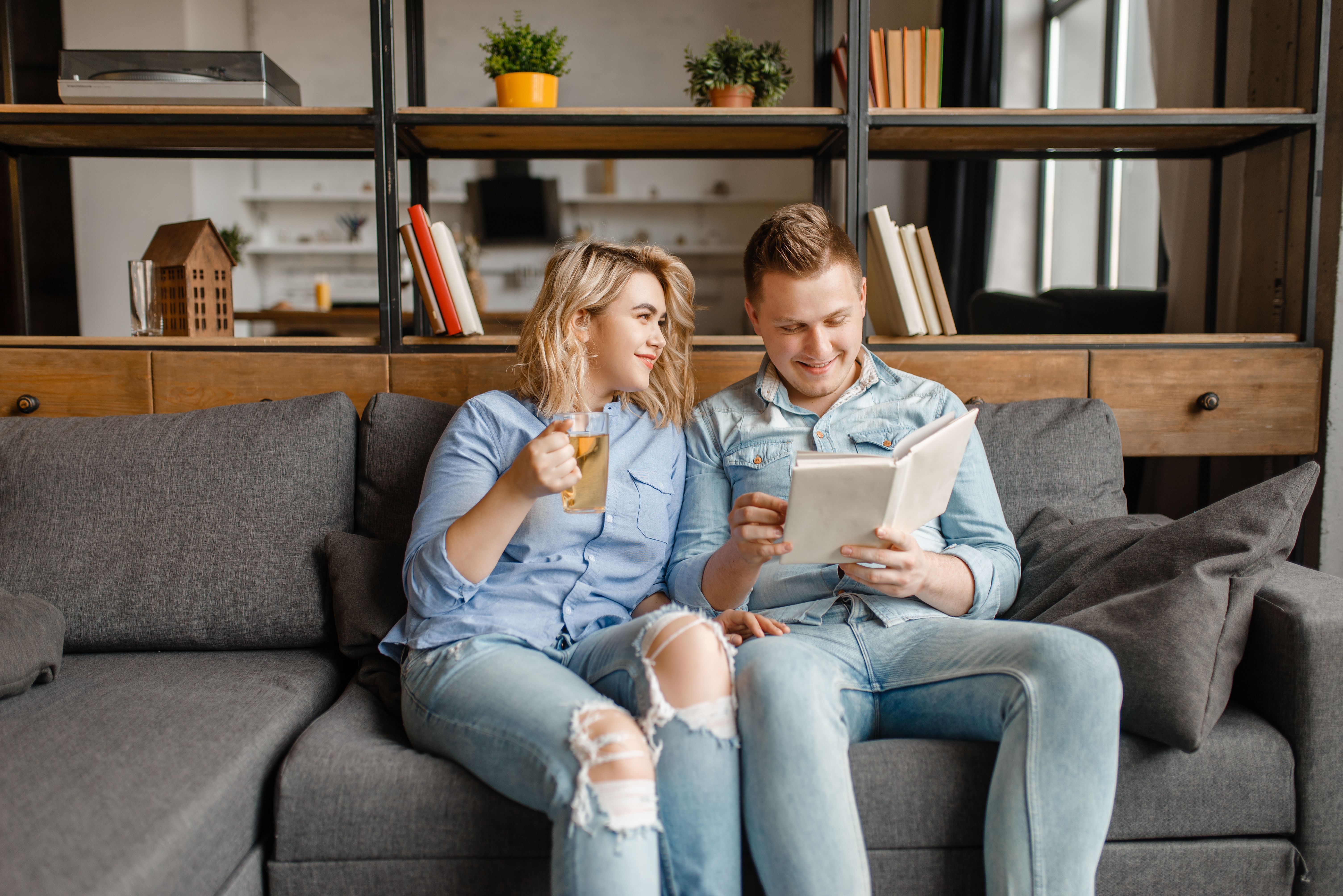 A young couple reading books and enjoying time at their new Build To Rent property.