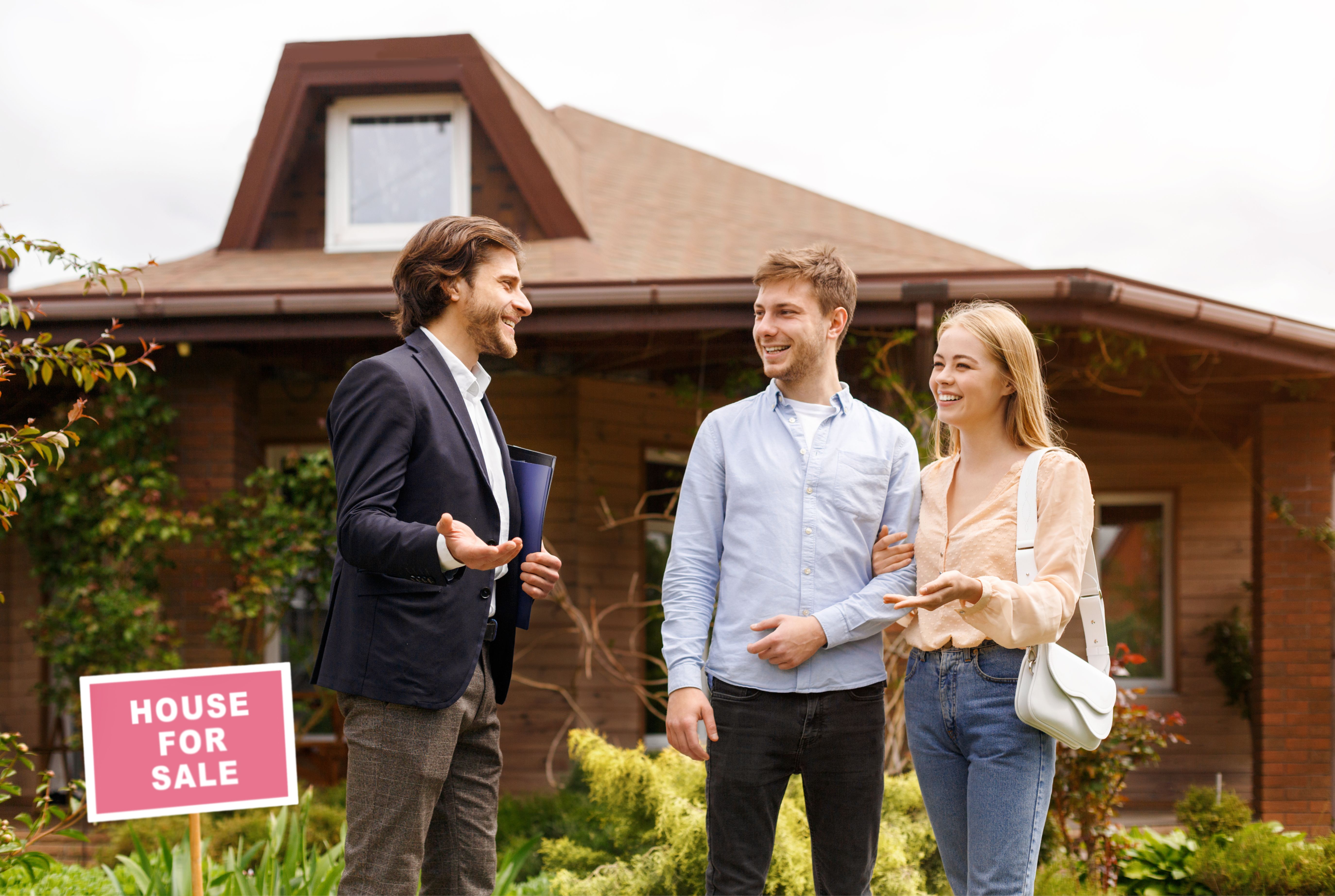 young family talking to real estate agent