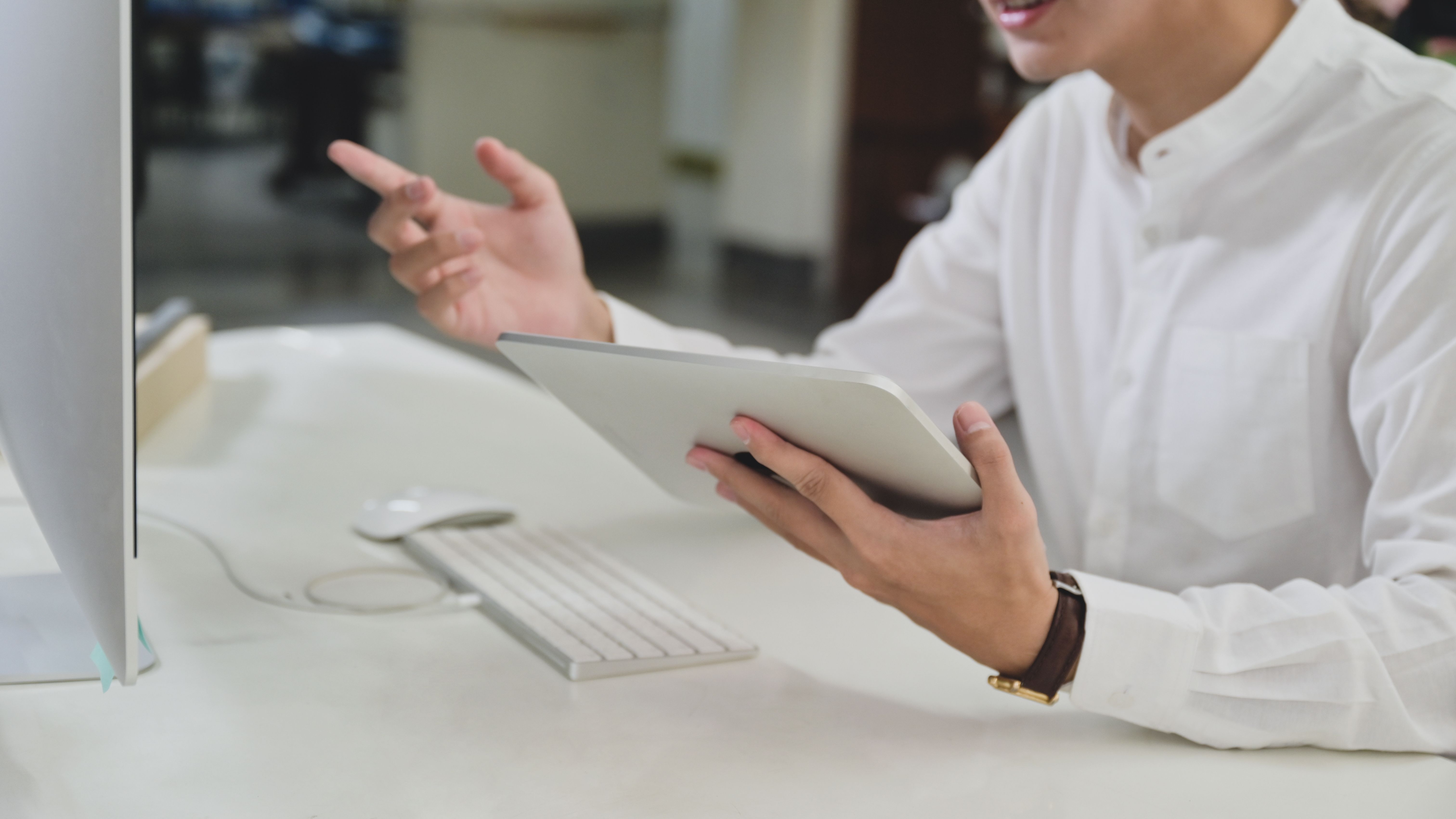 young man holding tablet and video conferencing