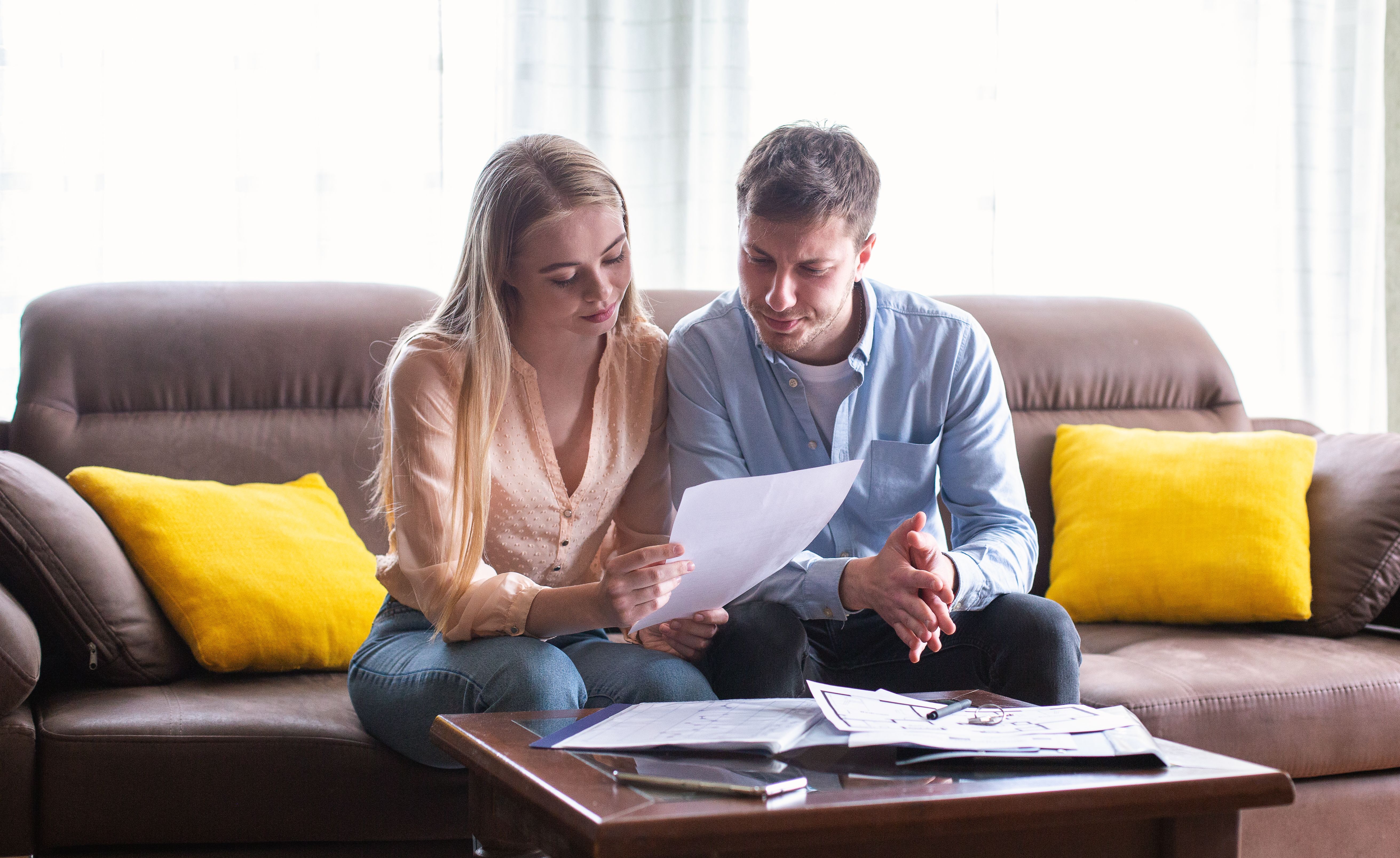 a young married couple looking through tenancy agreement