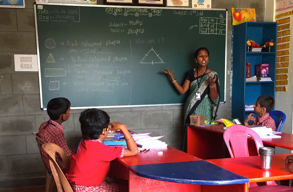 a teacher making diagrams on the blackboard