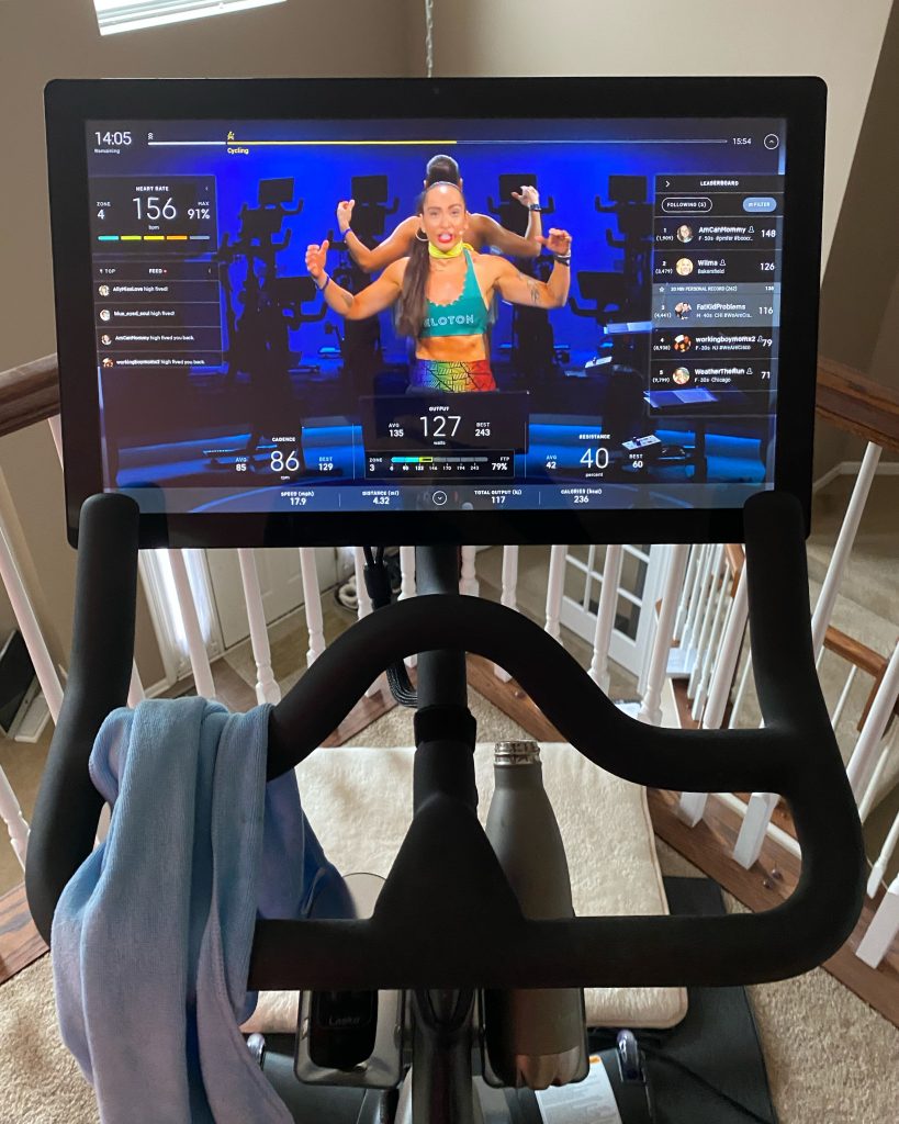 Rolly rides his Peloton with co-workers.
