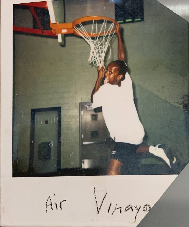 Vinaya dunking a basketball as a child. 