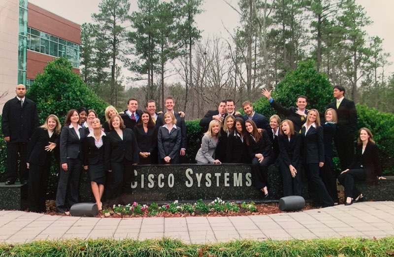 Ritchie and co-workers in front of Cisco sign. 