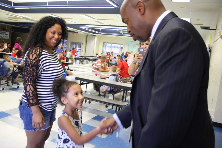 The CEO of New Teacher Center meeting with a young student