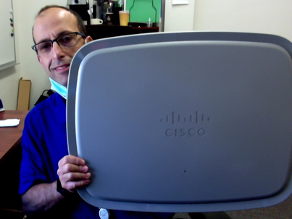 Shai Silberman, Director of Network Services at SJSU holding the Cisco Catalyst 9104 integrated stadium antenna