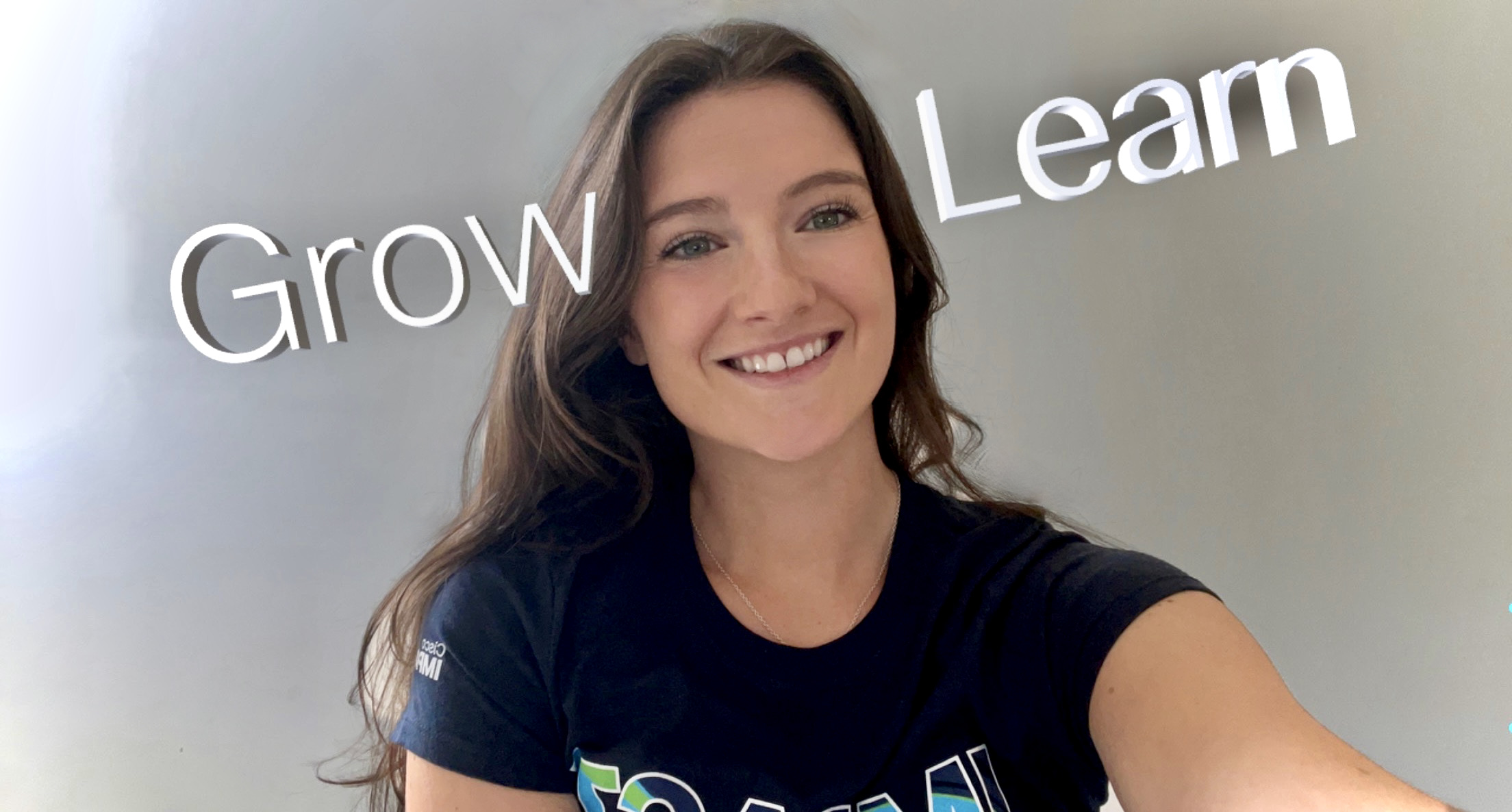 A selfie of Parker with the words "Grow, Learn" behind her. 