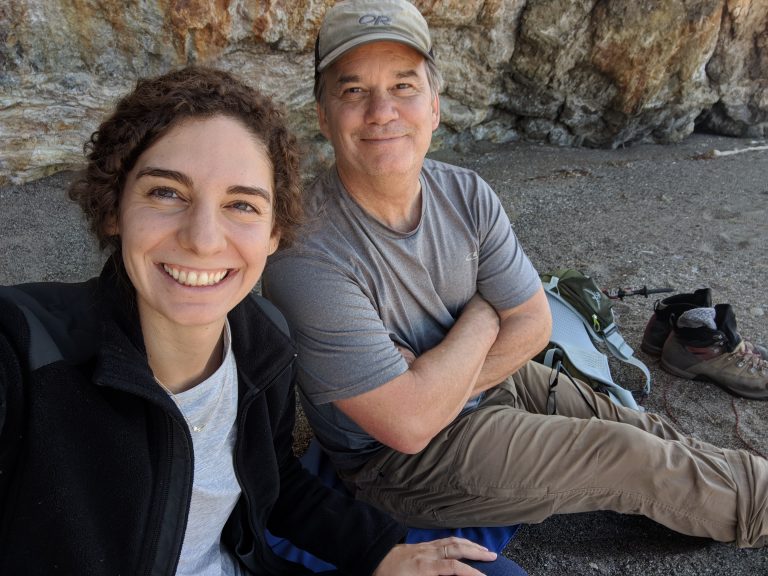 A man and a woman in an outdoor setting, smiling