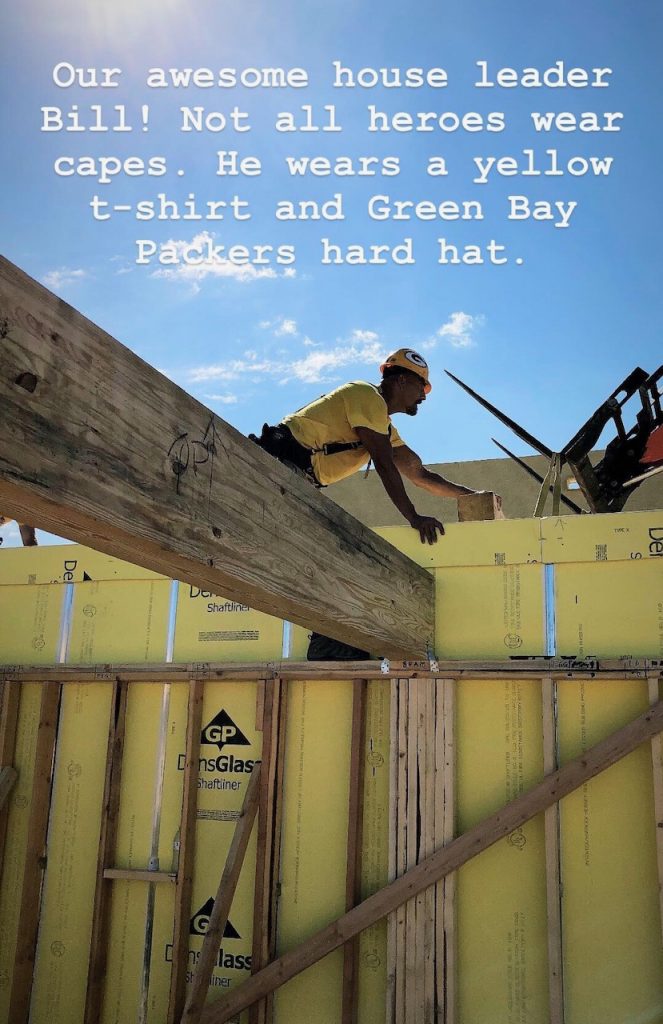 A man in a construction hat working on a house with text overlay