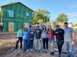 A group of people in front of a house they built