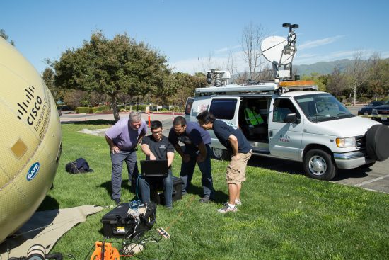 Cisco TacOps volunteers training on deployment of a portable satellite uplink