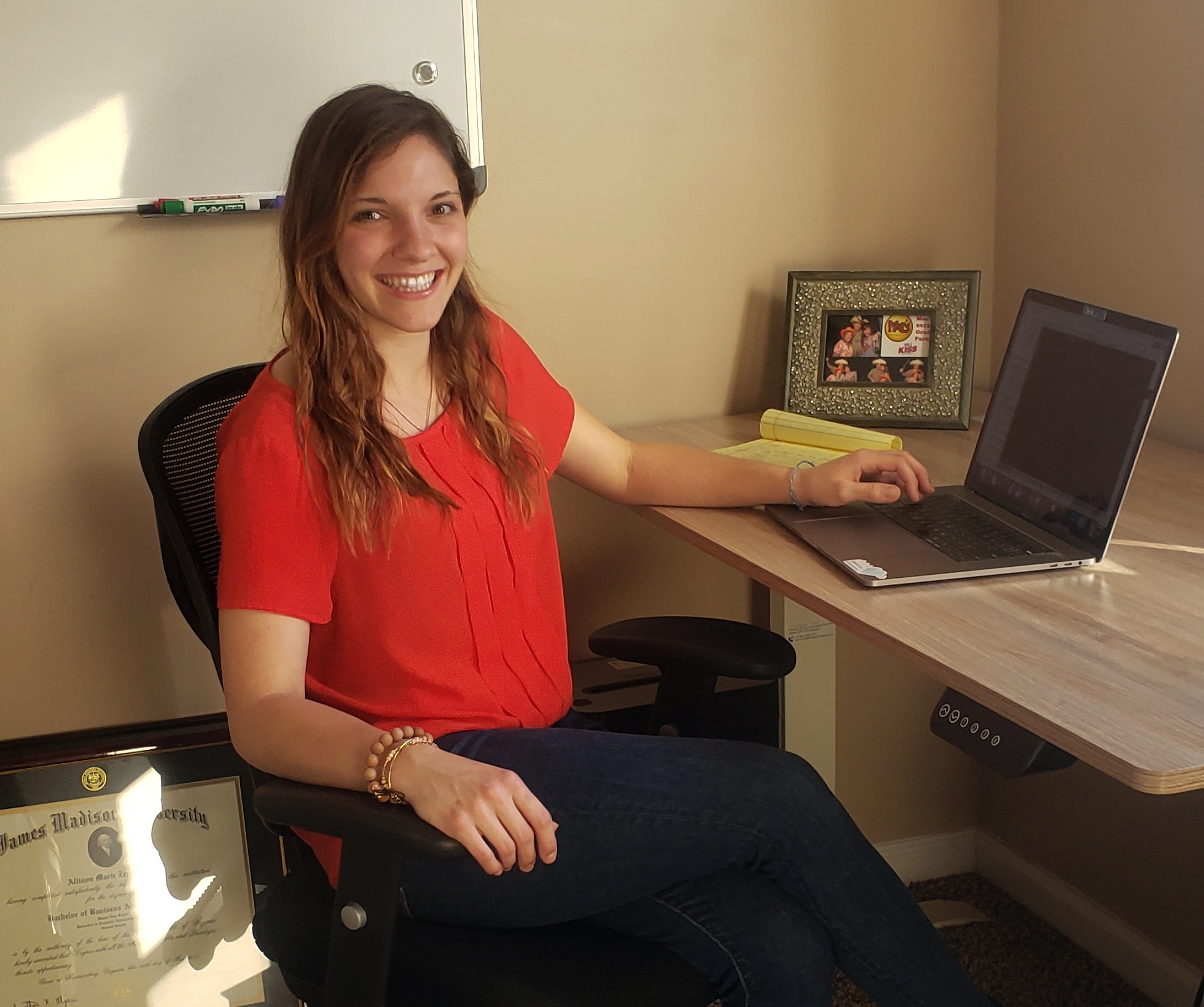 Allison Zeppuhar sits at her desk in front of her computer.