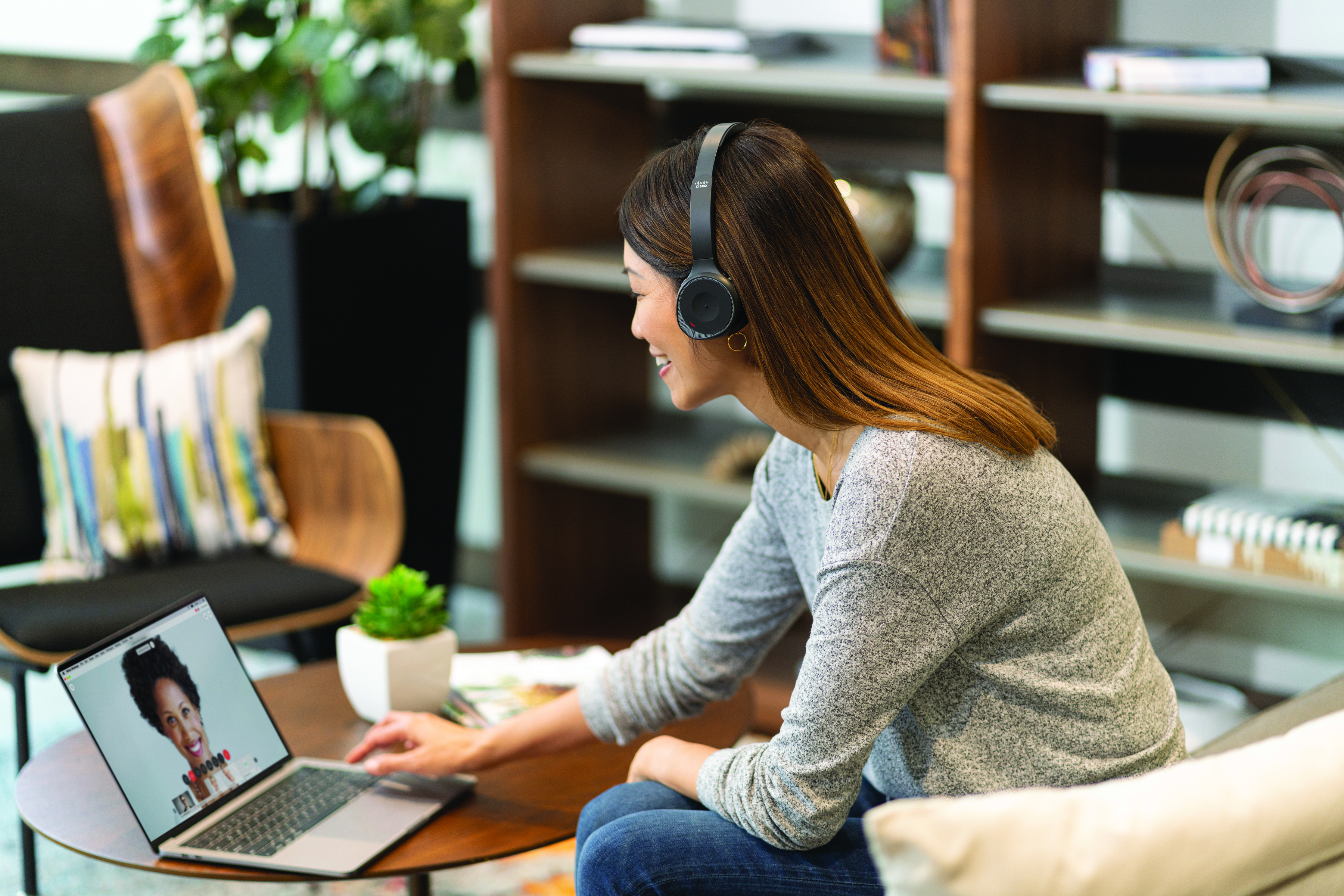 Woman wearing headphones looking at her laptop