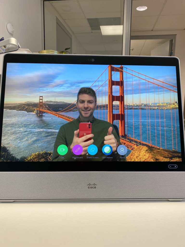 Ryan demonstrates how the new Desk Pro works by changing his virtual background to the Golden Gate bridge.