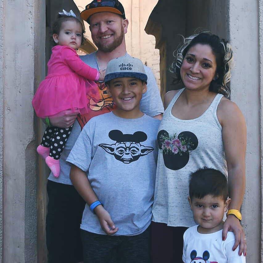 Nic and his family wear Disney shirts with his oldest son in a Cisco hat!