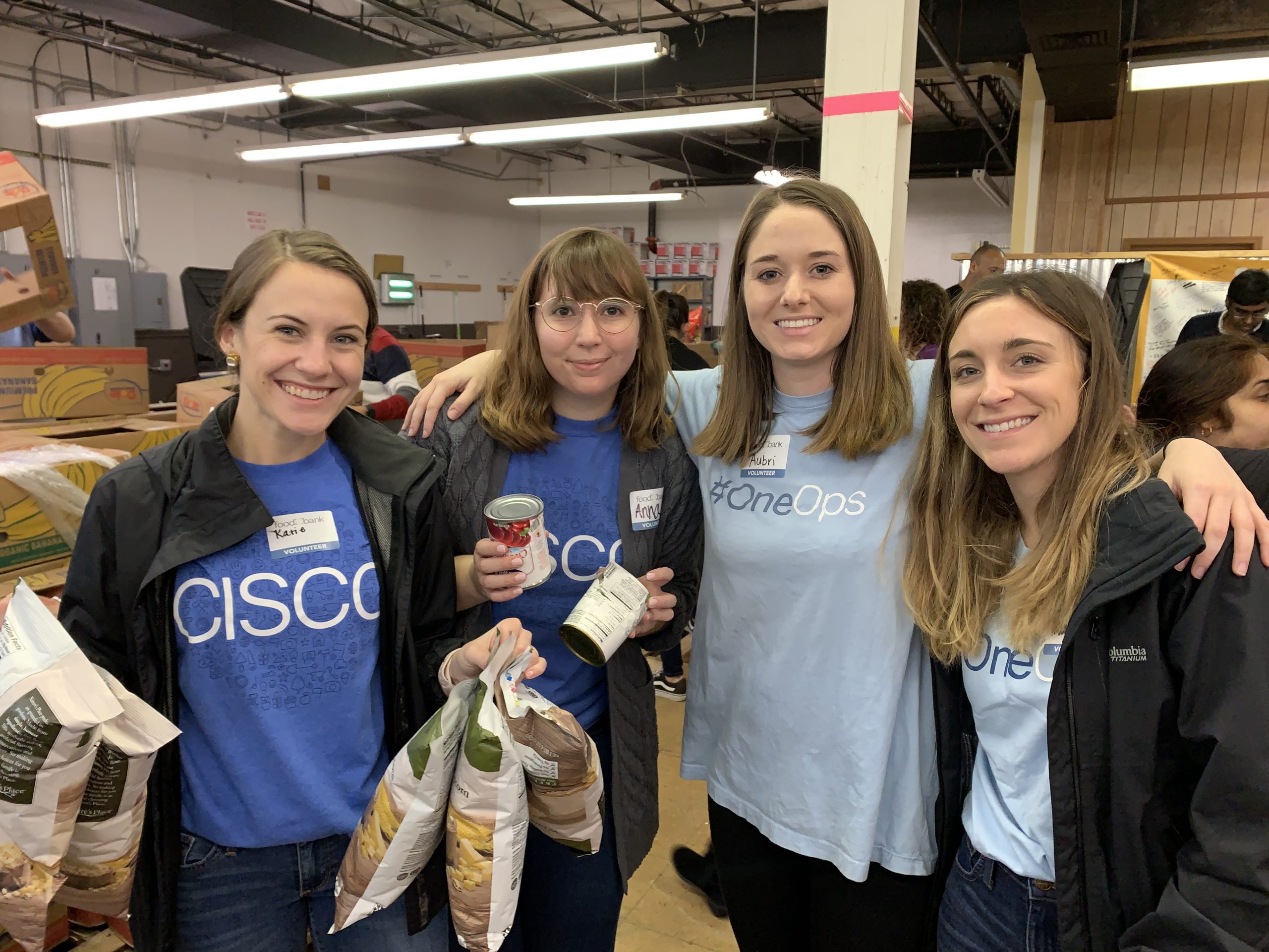 Katie with fellow employees at a giveback event.