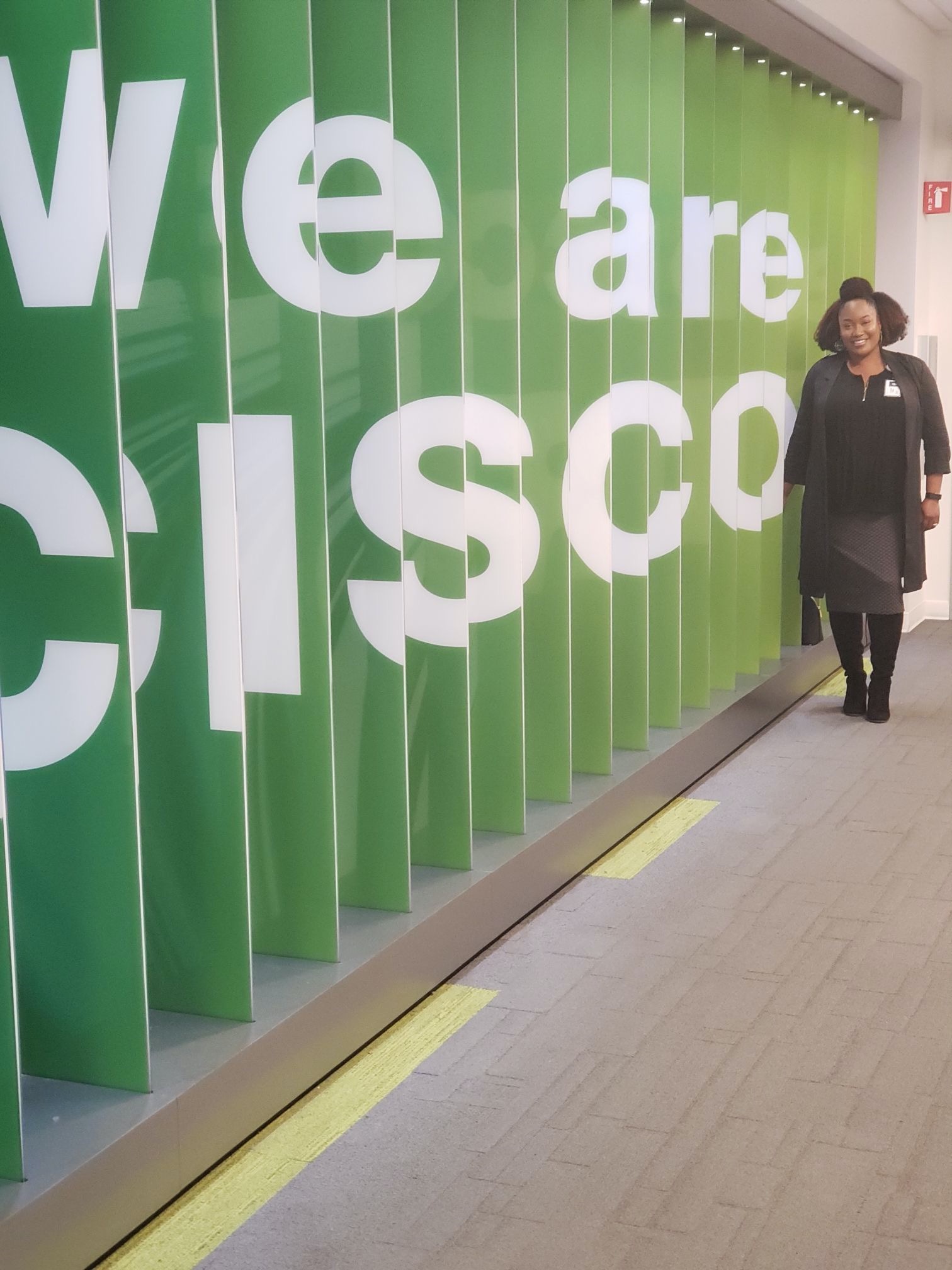 Tiara in front of We Are Cisco sign. 