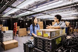 Two people talking in a warehouse