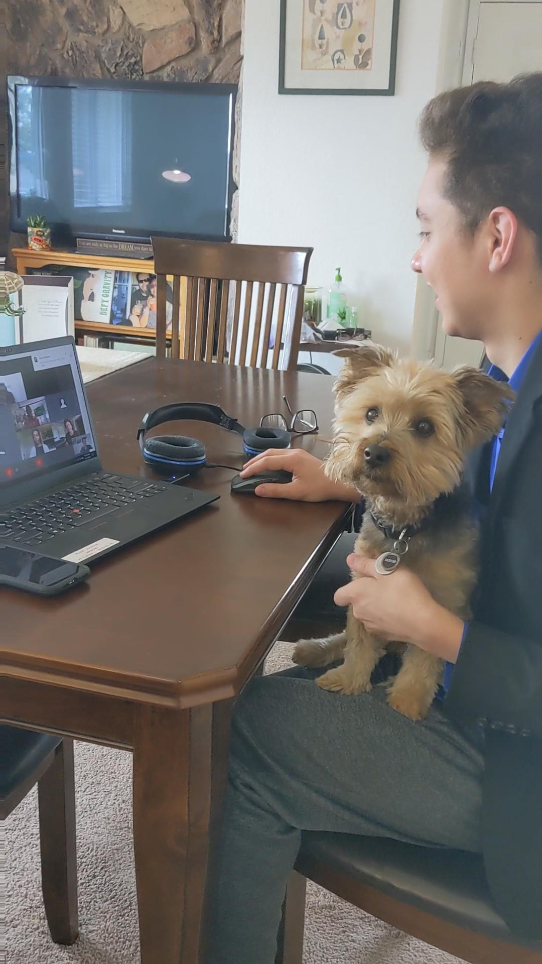Jonathan on a Webex call with his dog in his lap.