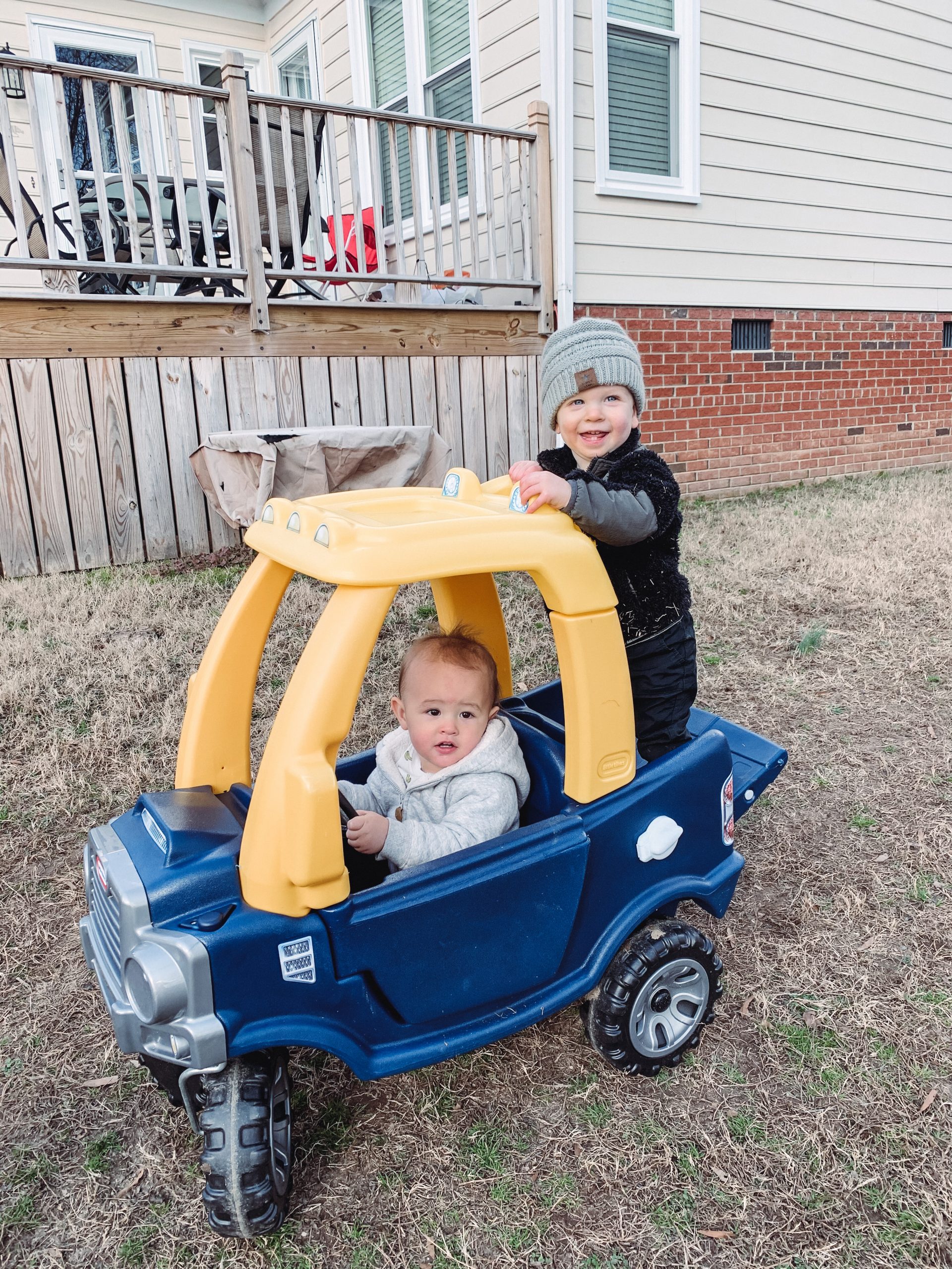 Jen and Ileana's sons riding in a play car together.