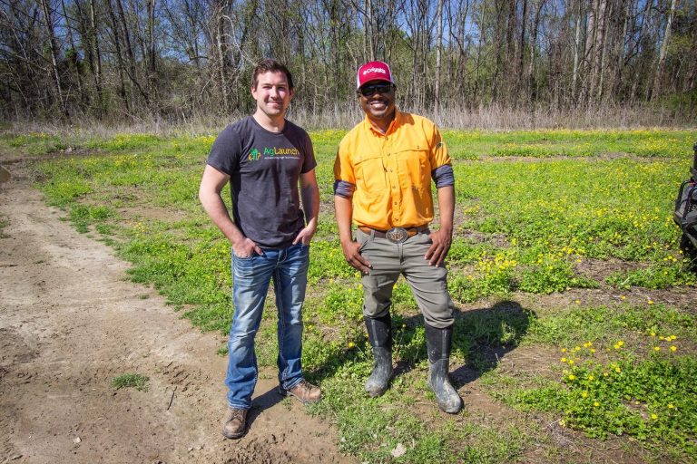 Two men standing together outside