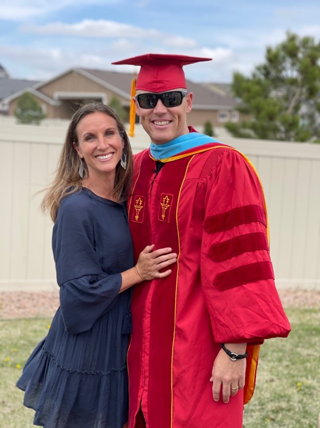Travis and his wife at his graduation.