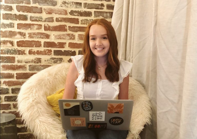 A young woman working on her laptop from home. 