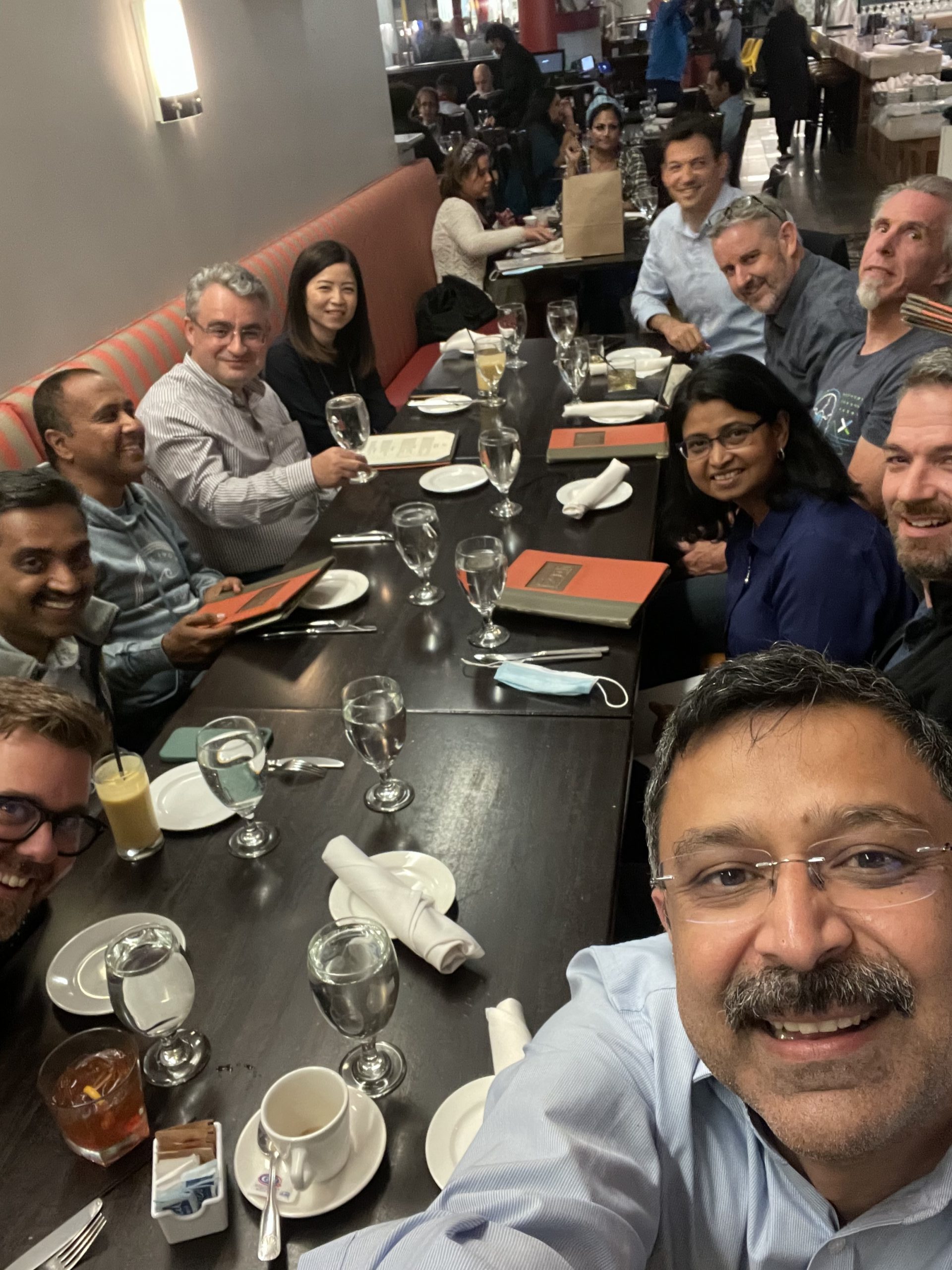 A group of people sit around a table at dinner.