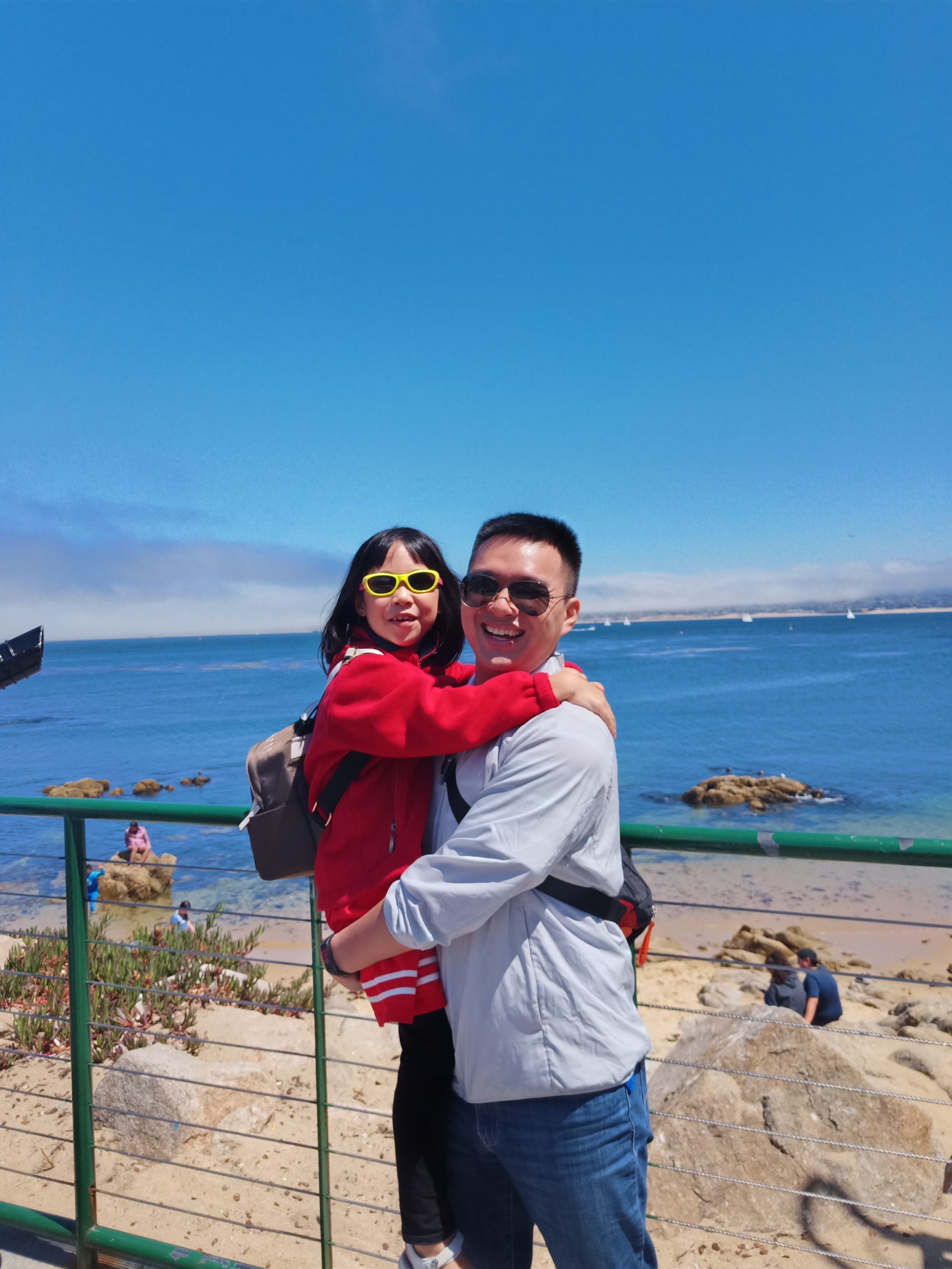 Toddy with his daughter while visiting the seaside near Cannery Row, Monterey, California.