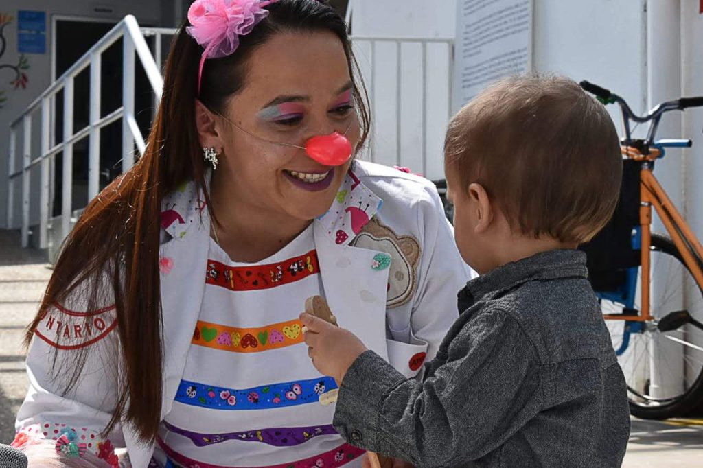 A woman dressed as a clown with a child