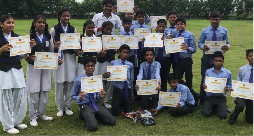 Students holding up certificates