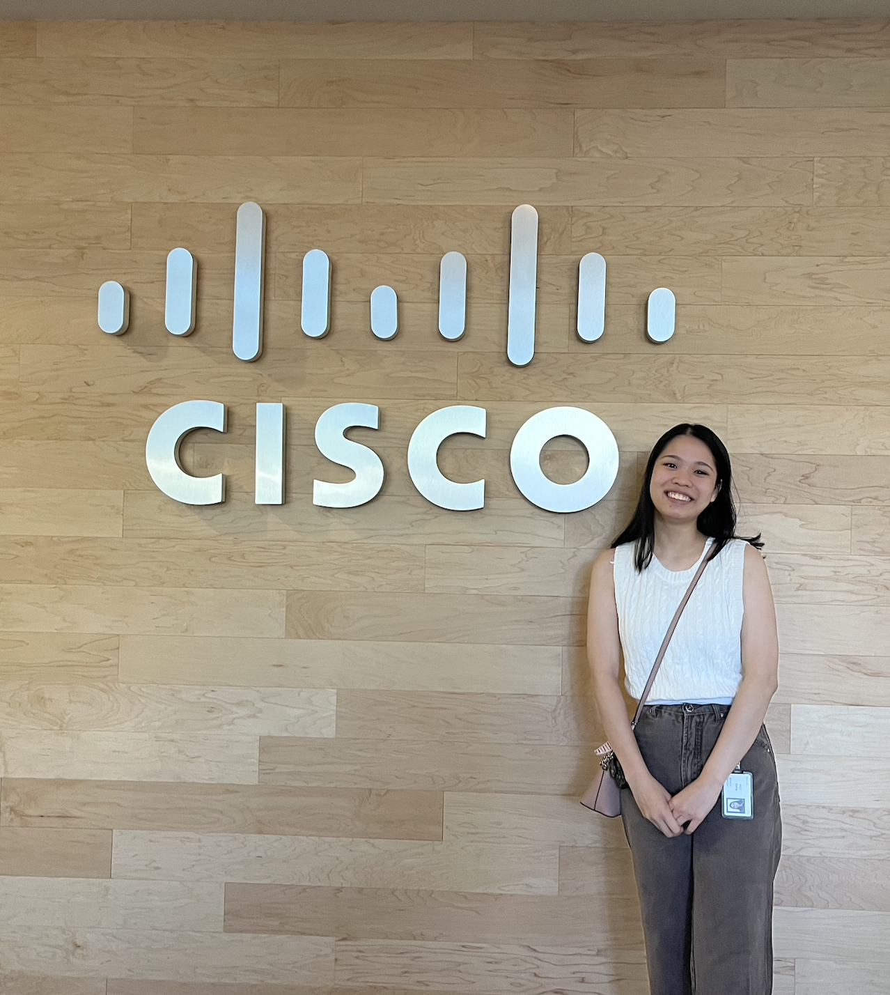 Kelly Chiv standing next to Cisco sign.