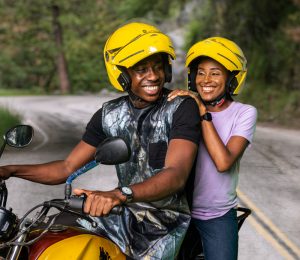 A man and woman on a motorbike.