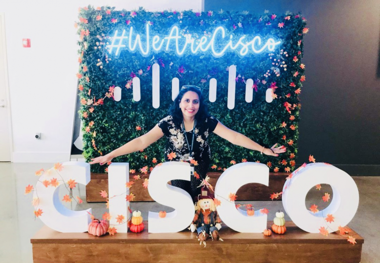 Naziya pictured with Cisco and #WeAreCisco signs.