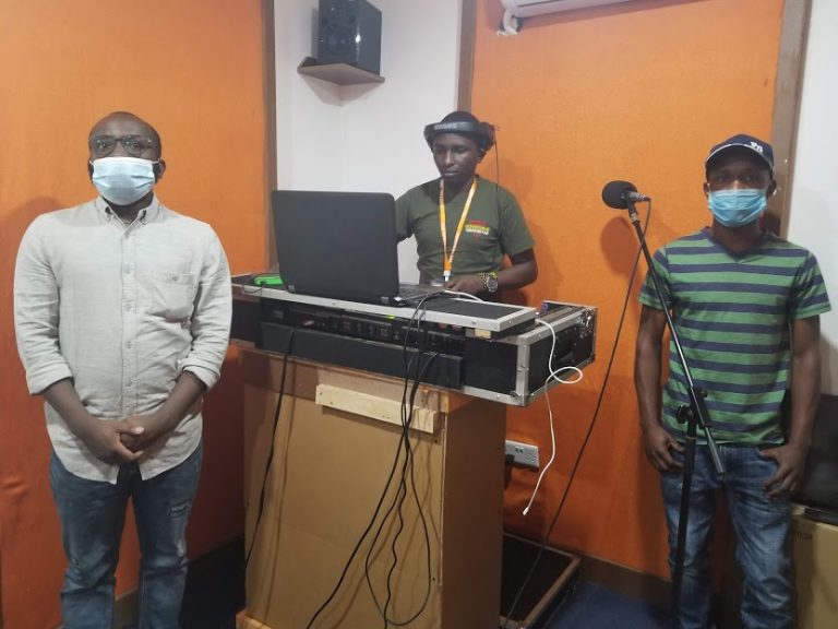 Three radio DJs from Kenya, wearing masks