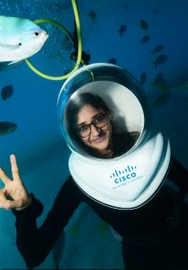 Woman underwater in Cisco branded scuba gear.