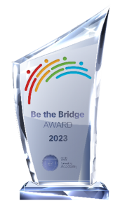 A clear glass award that says Be the Bridge