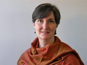 A woman wearing an orange scarf