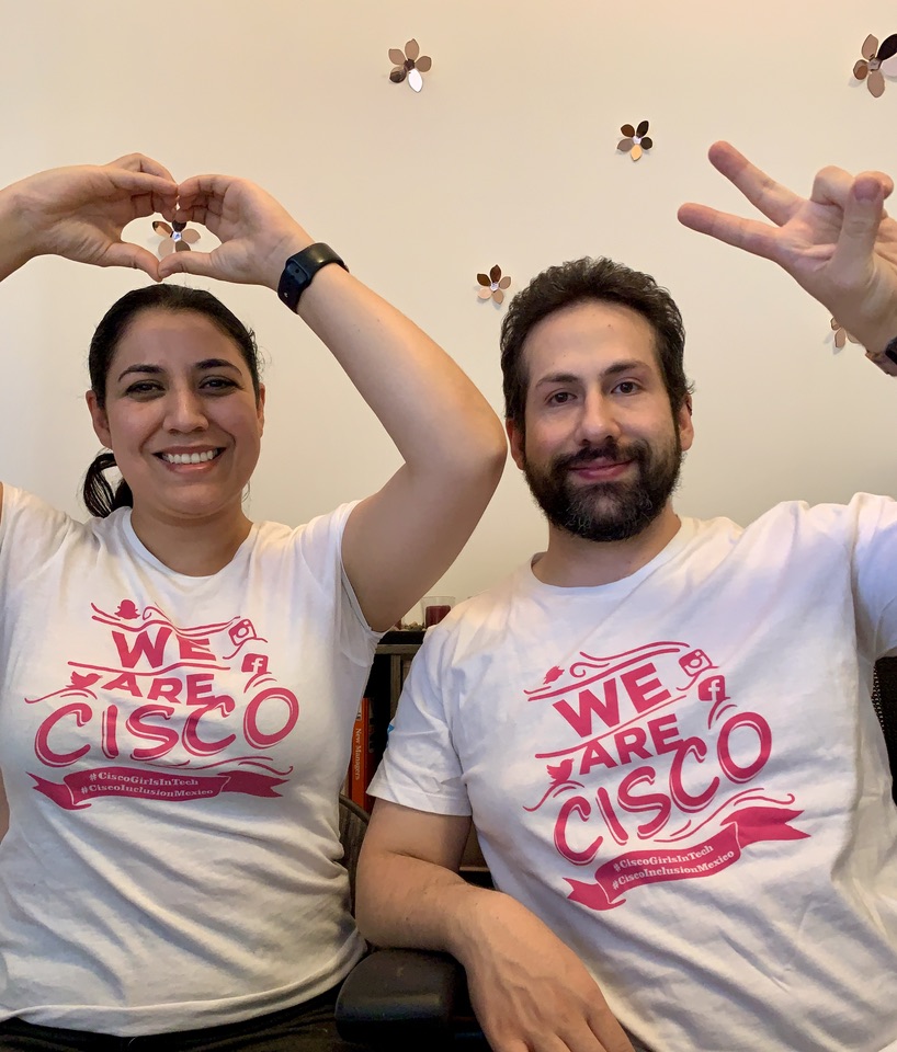 Carmen and a colleague wearing "We Are Cisco" shirts.