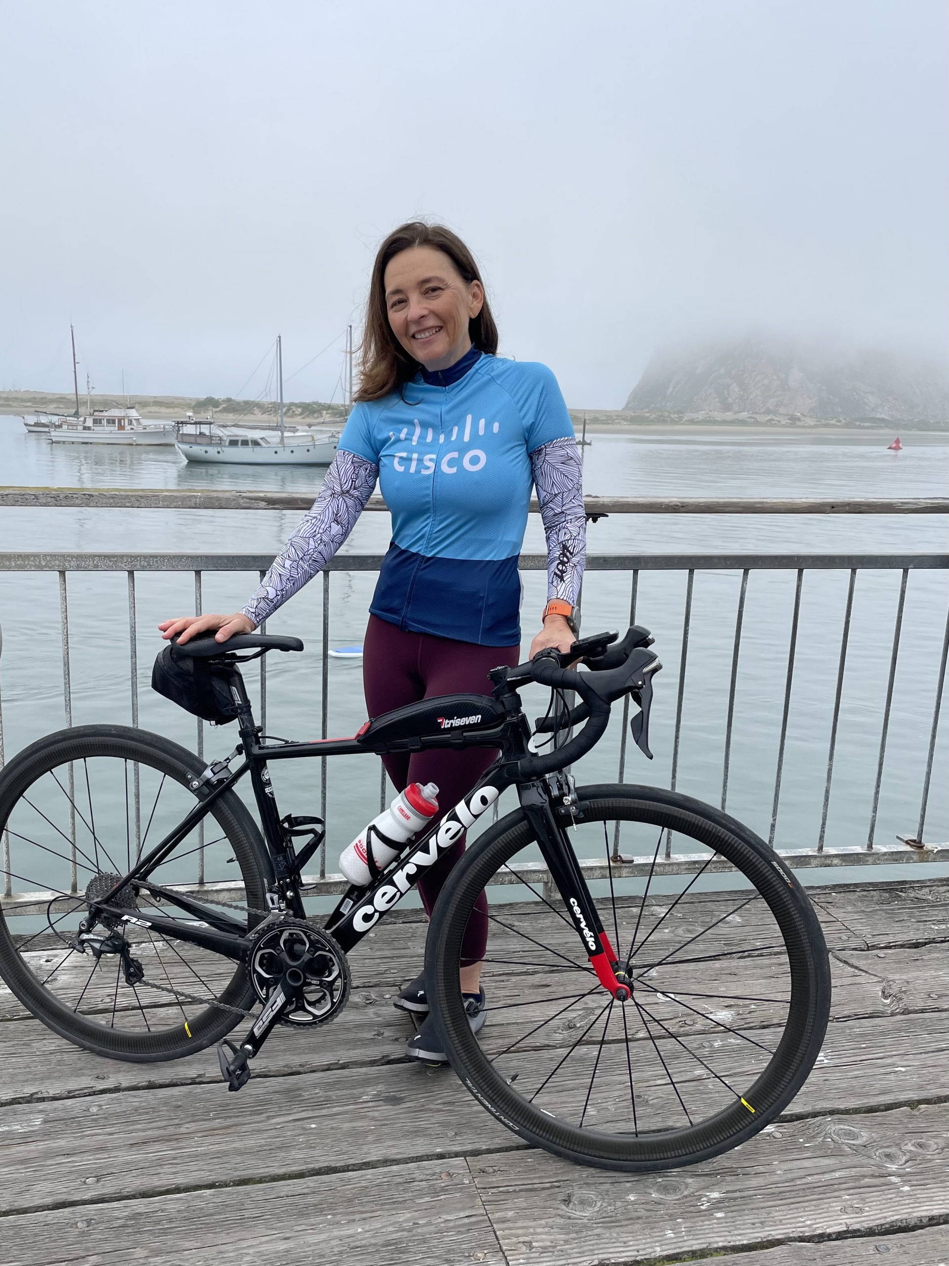 Maia wearing a Cisco shirt with her bike.